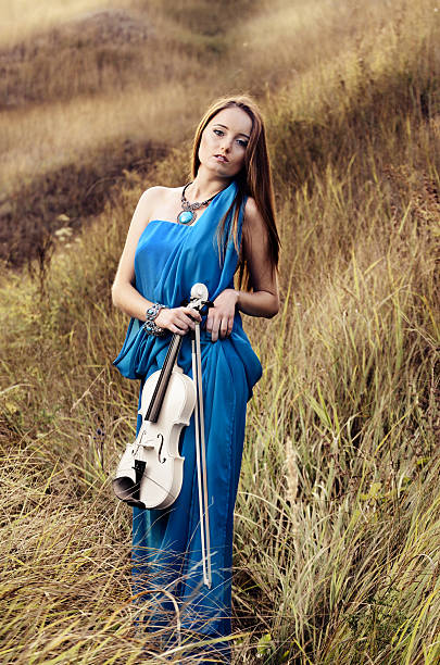 istock Young woman holds violin 186754049