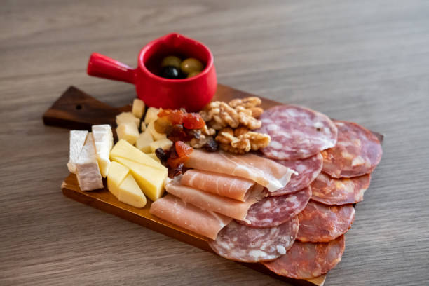cold cuts platter, variety of sliced meat and cheese with olives and nuts - coldcut zdjęcia i obrazy z banku zdjęć