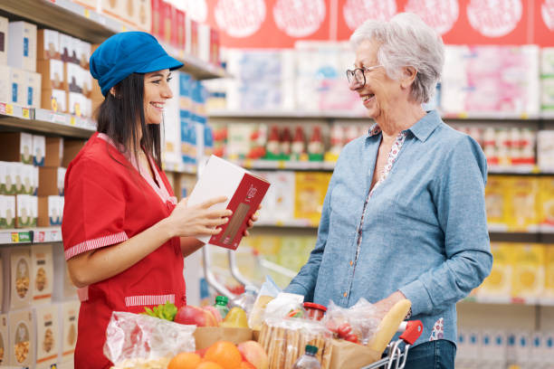 istock Supermarket clerk helping a senior customer 1867544468