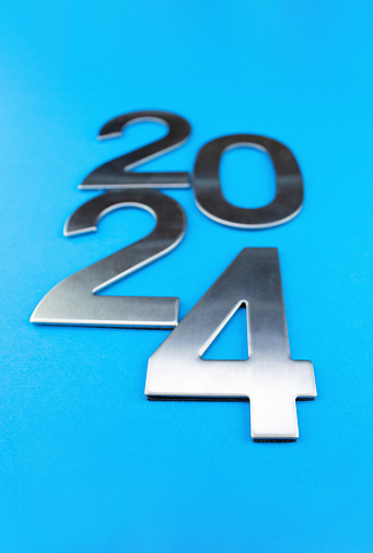 Composition with the number 2024 made of silver on a blue monochrome background