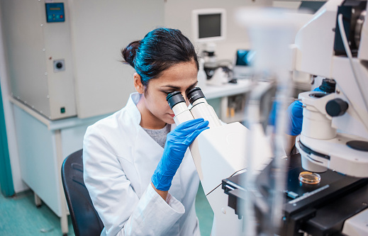 Female Scientist Working in The Lab, Using Microscope
