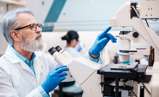 Male Scientist Working in The Lab, Using Microscope