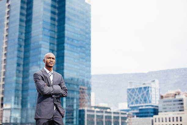 Confident african businessman with cityscape in the background.