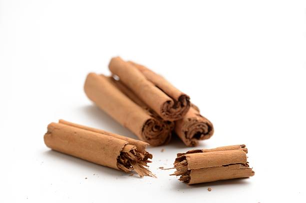 Arrangement of cinnamon sticks on white. Copy space and short depth of field