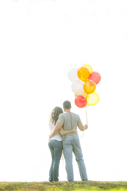 istock Young couple with balloons 186758027