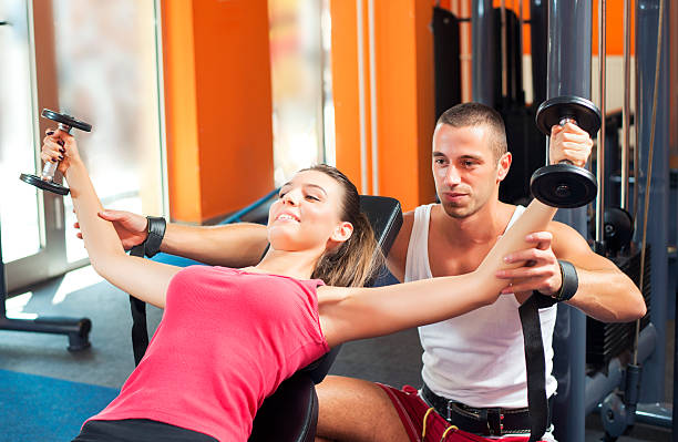 istock Personal Trainer in gym 186758288