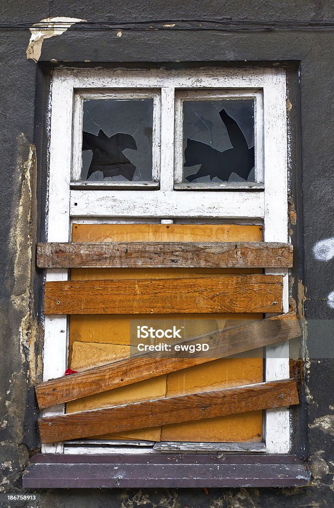 Old Window Old window with knocked out glass and boarded up. Boarded Up Stock Photo