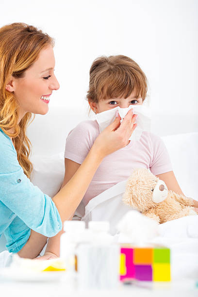 istock Mother Assisting Her Child To Blow Nose. 186759033
