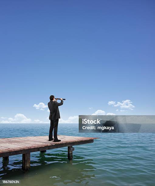 Businessman Looking Out To Sea With A Telescope Stock Photo - Download Image Now - Adult, Binoculars, Blue