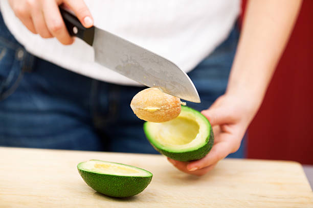 istock Young woman peeling avocado 186760815