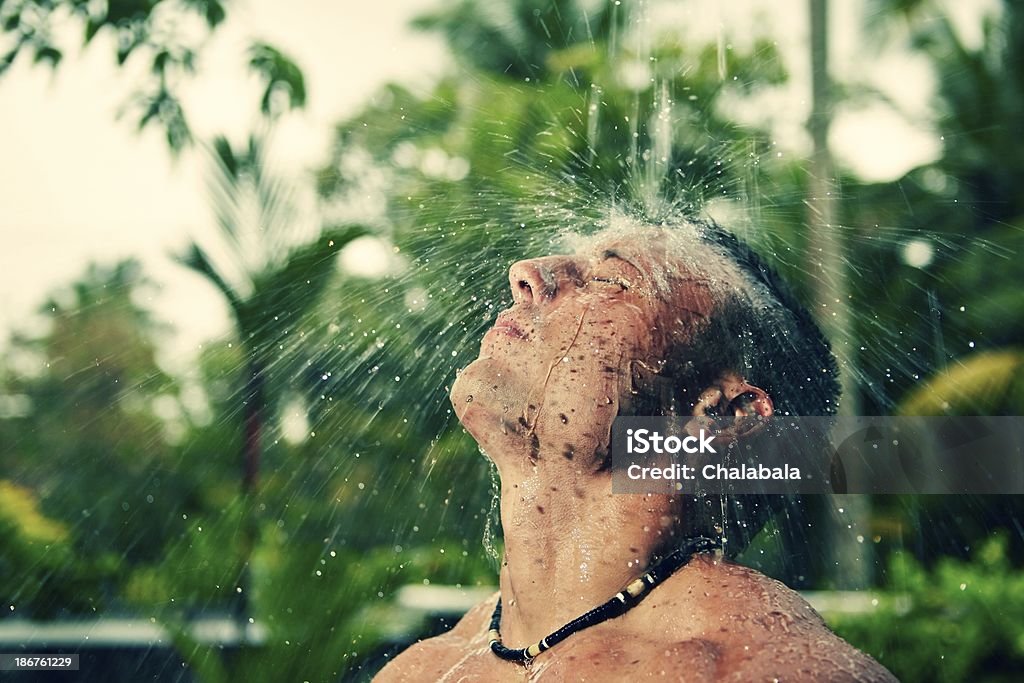 Man in the rain Muscular man is having shower in the rain. Men Stock Photo