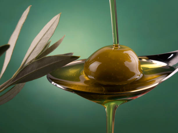 istock Olive oil and olive on a spoon 1867618486