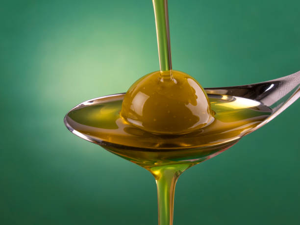 istock Olive oil and olive on a spoon 1867618994