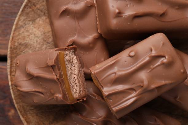 istock Tasty chocolate bars with nougat on table, top view 1867626299