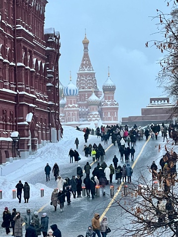 Moscow, Russia - December 16, 2023: Crowds of people walking towards Red Square