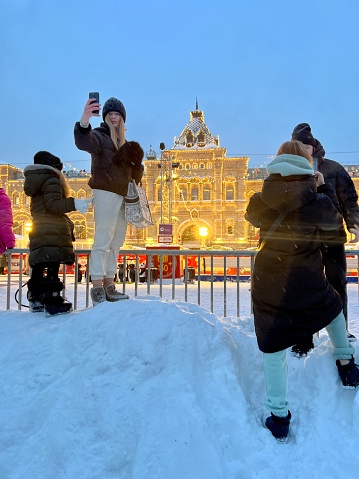 Moscow, Russia - December 16, 2023: Crowds of people on Red Square, enjoying snow, games and Christmas market