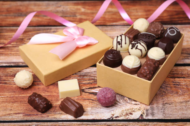 istock Box with tasty chocolate candies on wooden table 1867631127