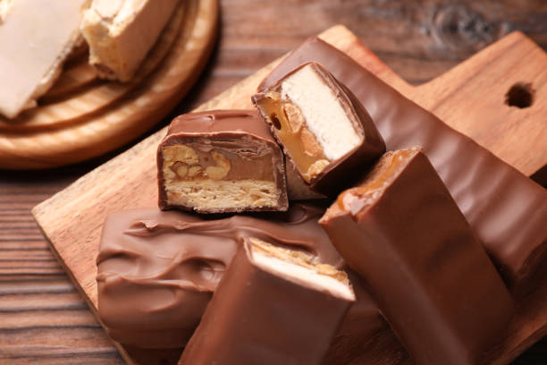 istock Tasty chocolate bars with nougat on table, closeup 1867632183