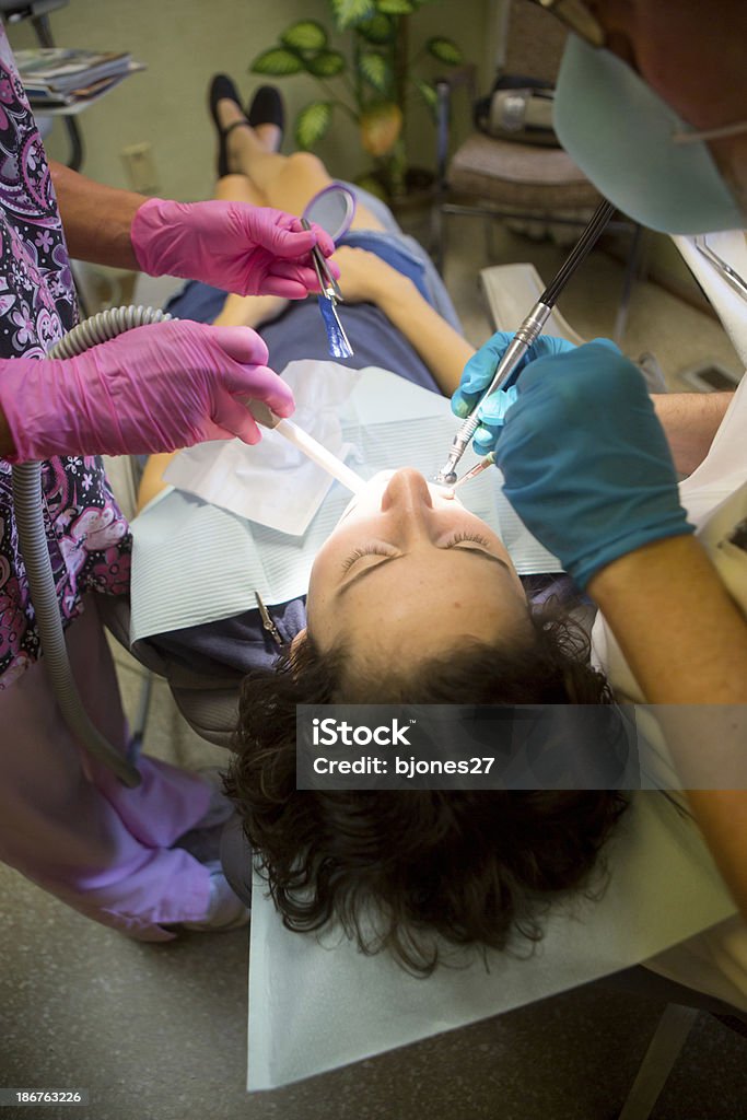 Young Woman Getting a Filling young woman in dentist's office having a cavity filled 20-24 Years Stock Photo