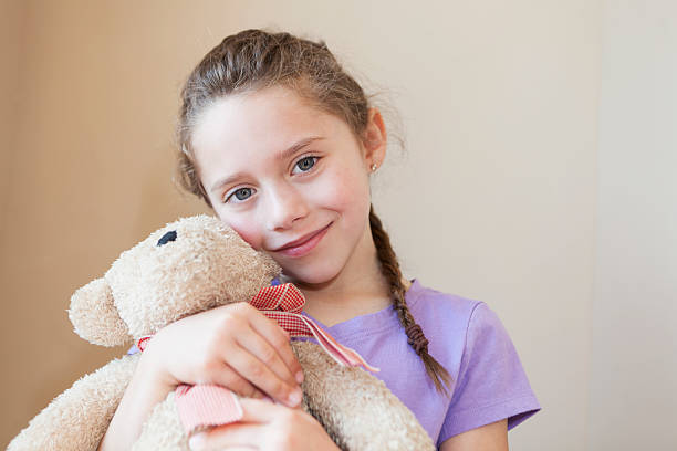 istock Little girl holding teddy bear 186763479