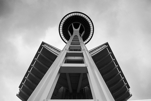 Seattle, Washington, USA - May 20, 1992:  Archival black and white view of the iconic Space Needle observation tower with cloudy sky.  Shot on film.