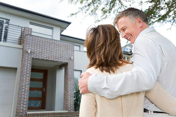 istock Mature couple looking at a house 186763768