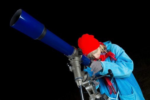 Adult woman observing the night sky using a three inch refracting telescope. AdobeRGB colorspace. More astronomy themes in this lightbox: