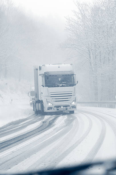 istock semi truck on a snowy mountain road 186764111