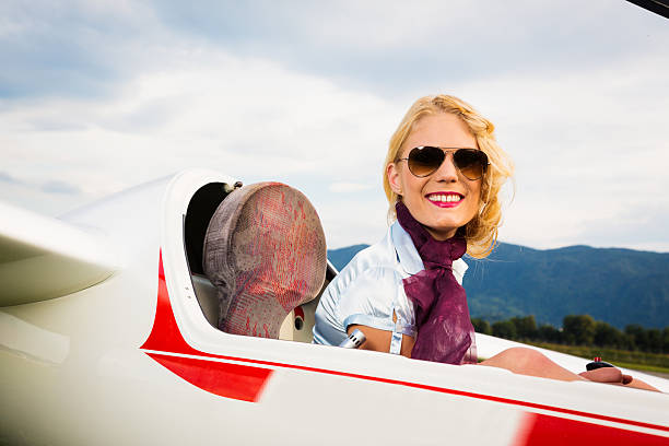 istock young woman sitting in glider plane 186764673