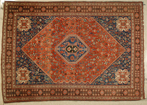 Antique Persian Qashqai'I tribal rug having five geometric medallions.