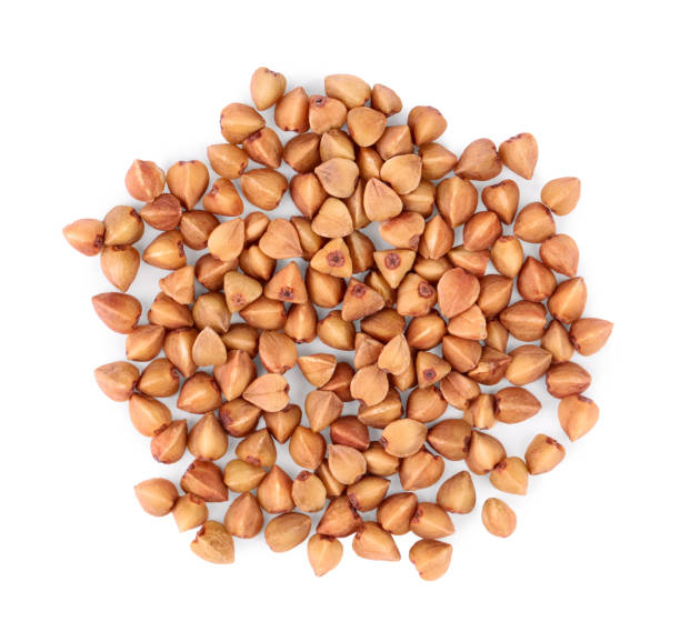 istock Many dry buckwheat grains isolated on white, top view 1867648823