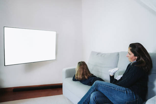 istock Mother and daughter watching TV 1867651999