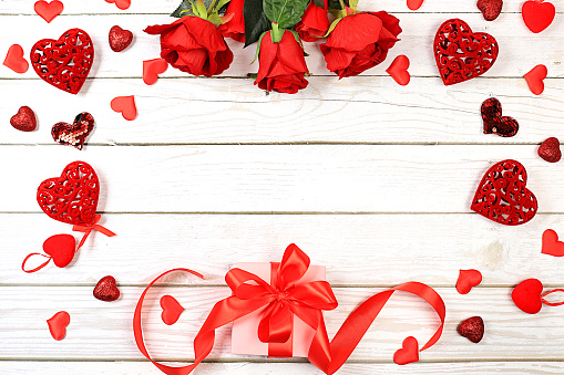 Celebration of Valentine's Day or Women's Day, Mother's Day, banner. Greeting card, roses, hearts and gift boxes on a wooden background, happy holiday, birthday greetings, selective focus