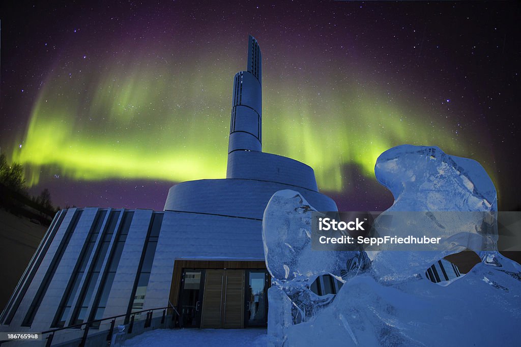Aurora borealis behind a cathedral in Alta Norway Northern lights cathedral Alta Norway with aurora borealis, a new spectacular building which will be finished 2013. Sculptures of ice on the way to the church. Alta - Norway Stock Photo