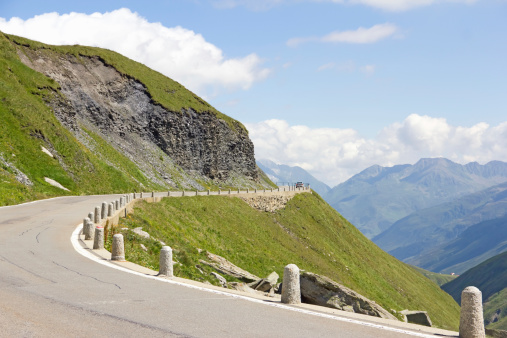 Car driving a mountain road in Alps