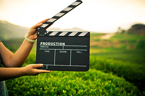 istock A female holding a clapper board while shooting outside 186767035