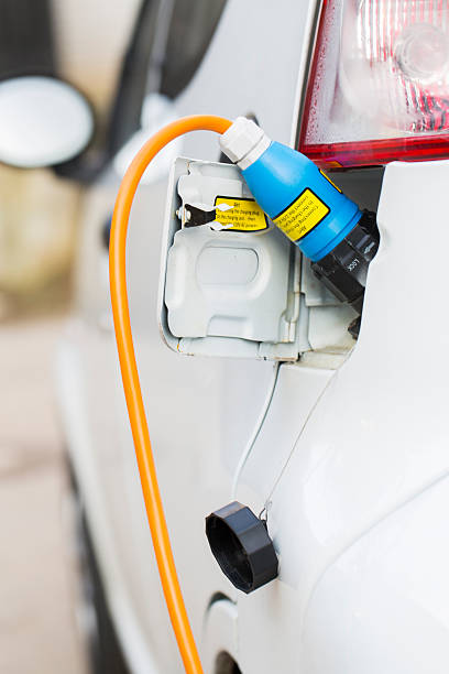 istock Closeup of an electric car plug while recharging 186767881