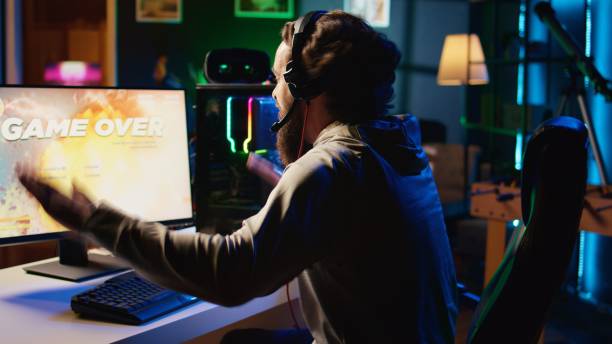 Angry gamer raging in frustration after losing level while playing spaceship videogame