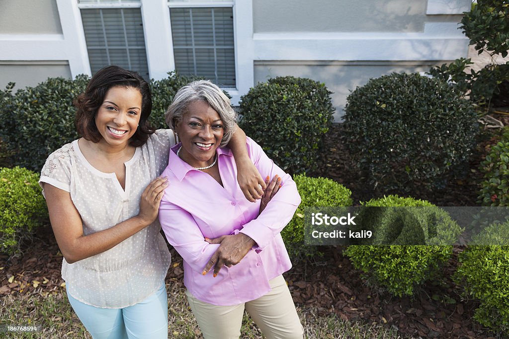 Woman with adult daughter African American woman with adult daughter. In Front Of Stock Photo