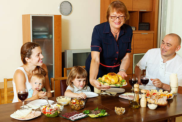 istock elderly woman serving baked chicken to table 186768704
