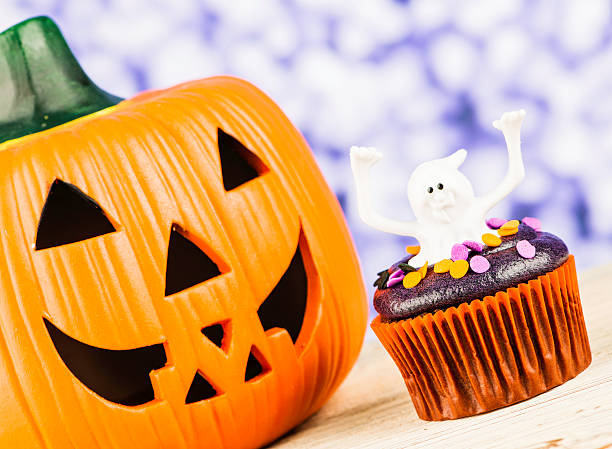 istock Little Ghost Halloween Cupcake and Giant Pumpkin 186768980
