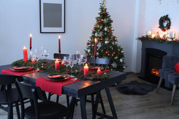 istock Elegant Christmas table setting with dishware and burning candles in festively decorated room 1867693100