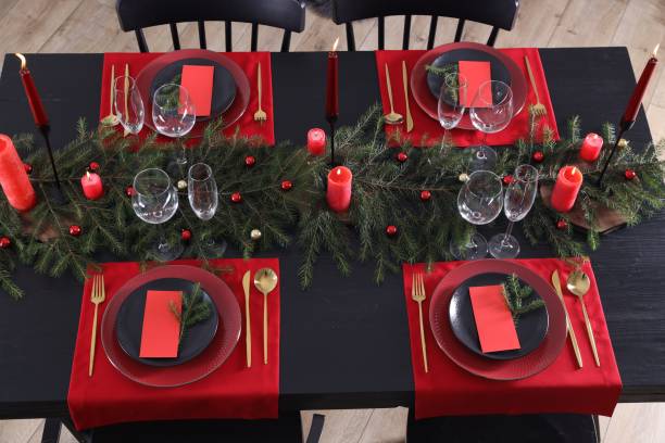 istock Elegant Christmas table setting with burning candles, decor and place cards for festive dinner, above view 1867693637