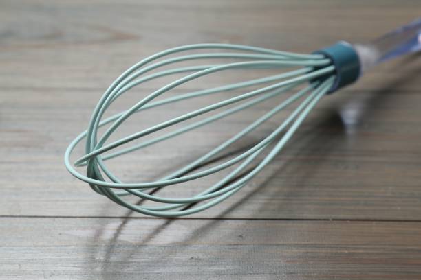 istock One whisk on wooden table, closeup. Kitchen tool 1867696858