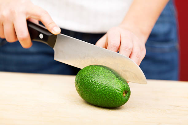 istock Young woman peeling avocado 186769775
