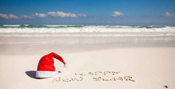 istock Happy New Year written in sand and Santa Hat 186770154