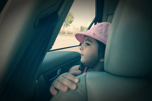 istock little girl in car 186770492