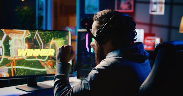 istock Cheerful man achieving victory in gaming session, overflowing with joy 1867712954
