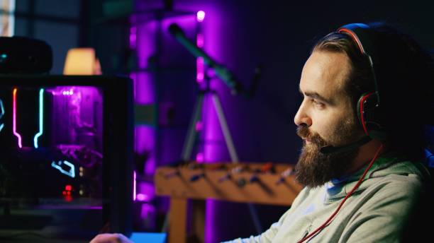 istock Zoom in on man discussing with friends online while playing singleplayer videogame with spaceship 1867714004
