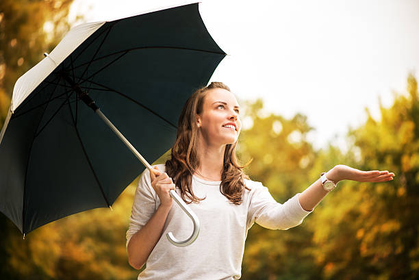 istock Young woman with umbrella 186771836
